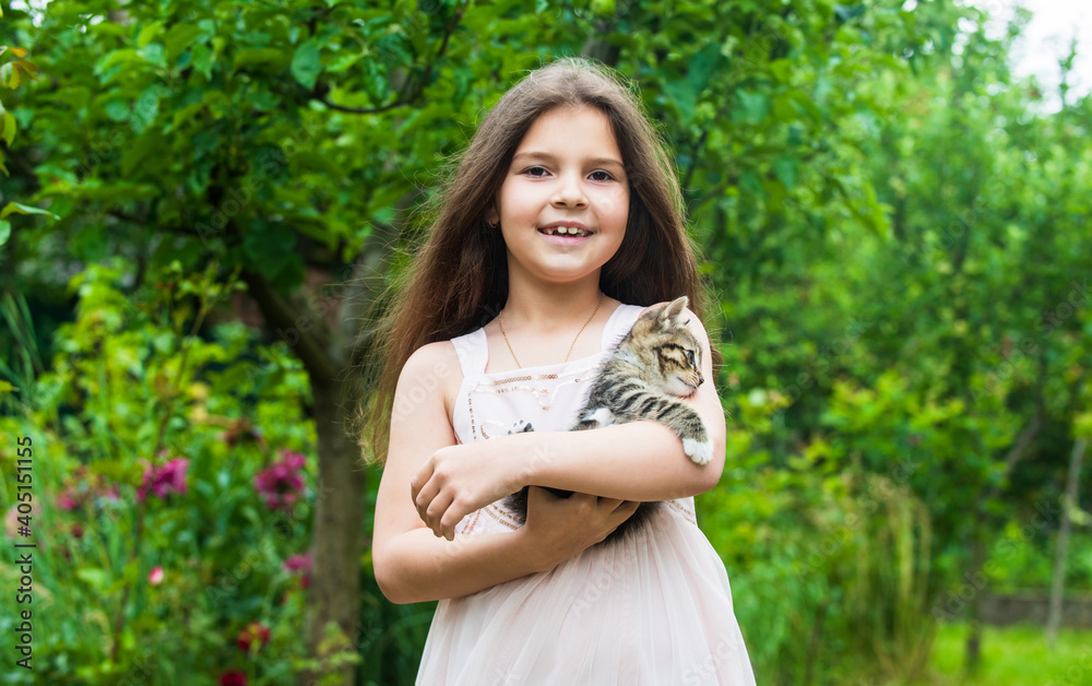 Little girl play with cute kitten cat nature background, childhood happiness concept Little girl play with cute kitten cat nature background, childhood happiness concept