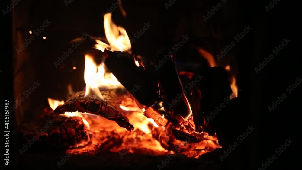 Orange flames, burning fuel briquettes and wood in the fireplace. Sparks Orange flames, burning fuel briquettes and wood in the fireplace. Sparks
