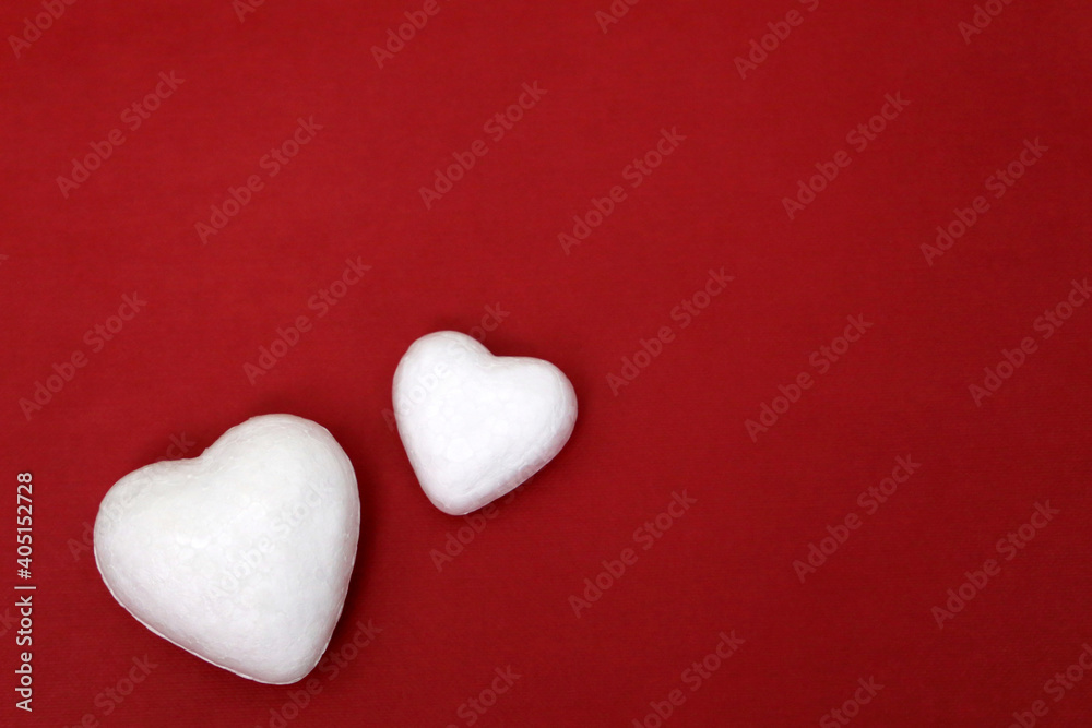 White Valentine hearts on red background. Two symbols of love, background for greeting card White Valentine hearts on red background. Two symbols of love, background for greeting card