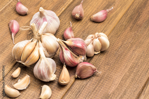 Heads and cloves of garlic on wooden background