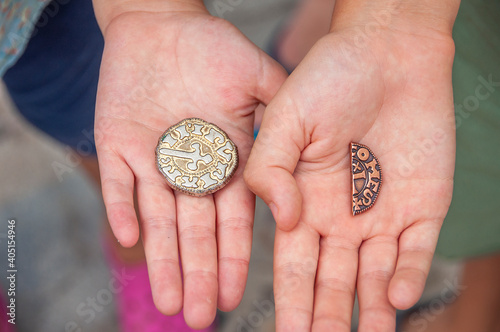 08.09.2019. MEDIEVAL FESTIVAL IN CASTELLON DE AMPURIA, SPAIN. Medieval coins on hands, close up. photo