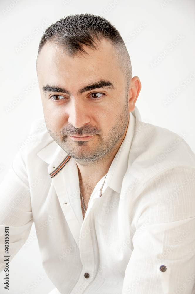 Portrait of a charismatic man with a white shirt. Confident, trustworthy, friendly man, ordinary guy.
