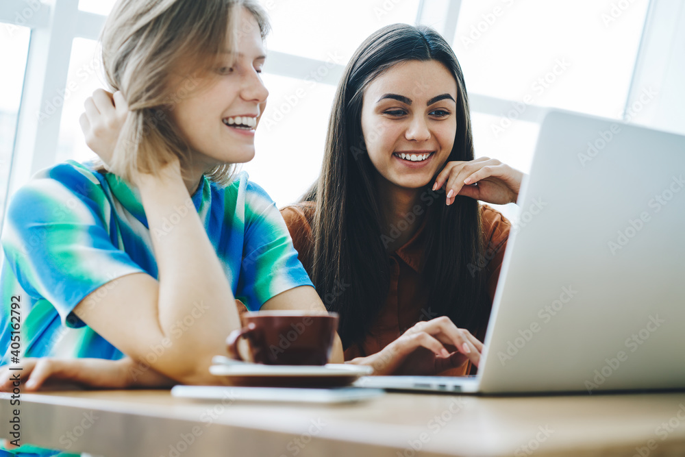 Female friends sharing laptop spending time together Female friends sharing laptop spending time together