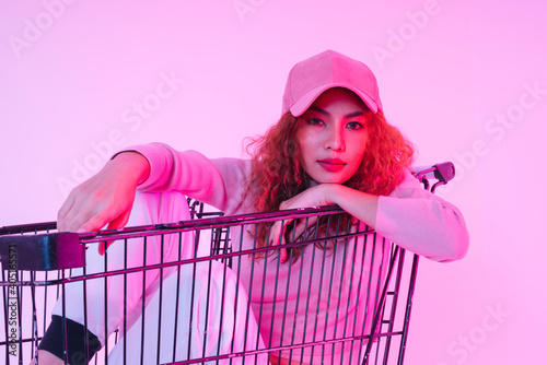 Portrait of young curly hair woman wear hat sitting in shopping trolley.