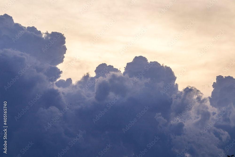 Dark clouds moving in the sky and rapidly changing shapes with the sun in the background at sunset. Dark clouds moving in the sky and rapidly changing shapes with the sun in the background at sunset.