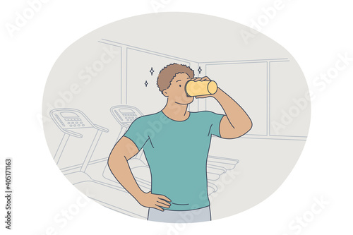 Professional sport, workout, training concept. Young man athlete standing and drinking water after training in gym and feeling energetic. Active lifestyle, fitness, bodycare, wellness