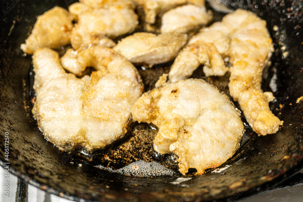 cooking fried fish in a pan plates cooking fried fish in a pan plates