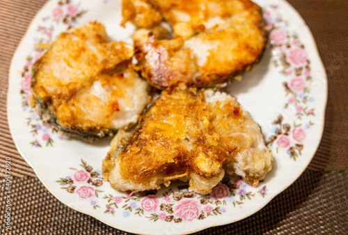 cooking fried fish in a pan plates