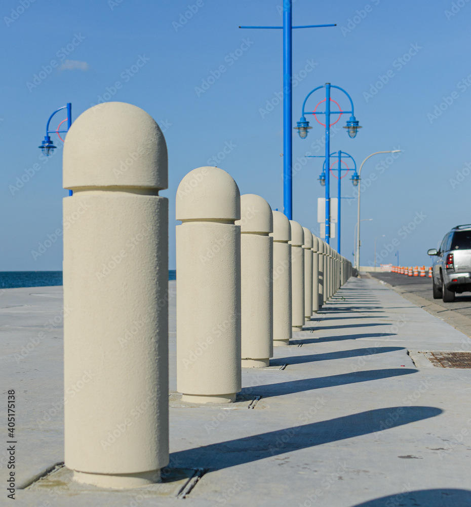 Line of concrete barriers and shadows along Lakeshore Drive in New Orleans, Louisiana, USA