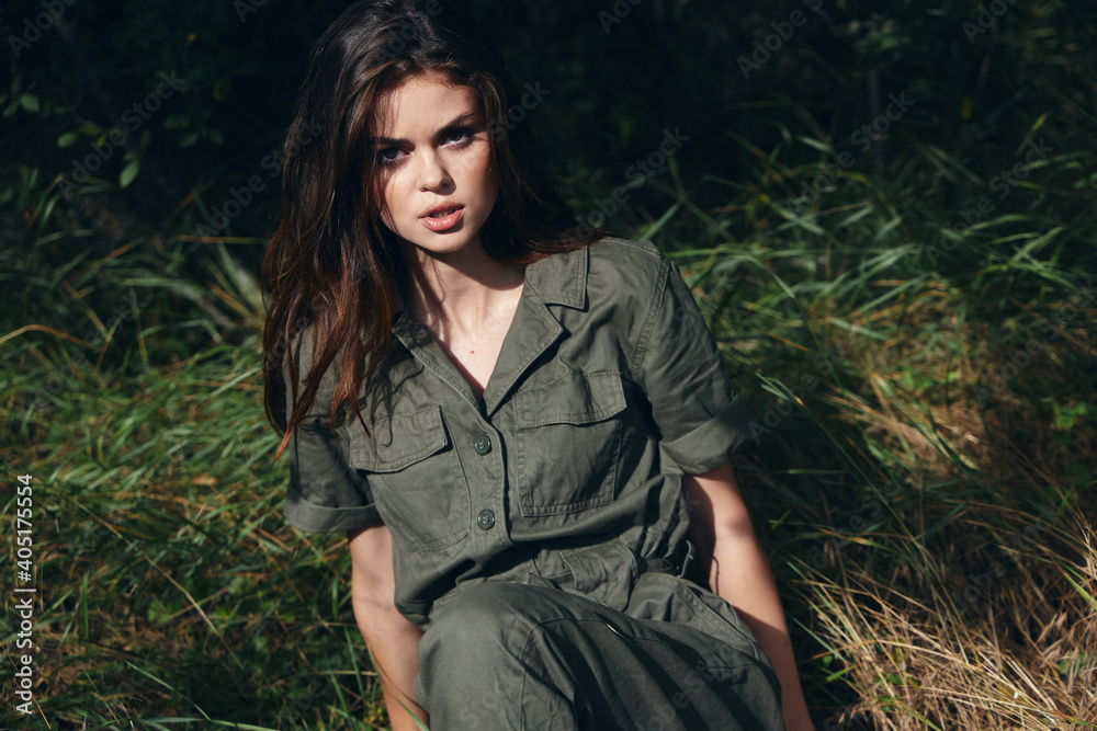 woman sitting on the grass looking ahead fresh air 