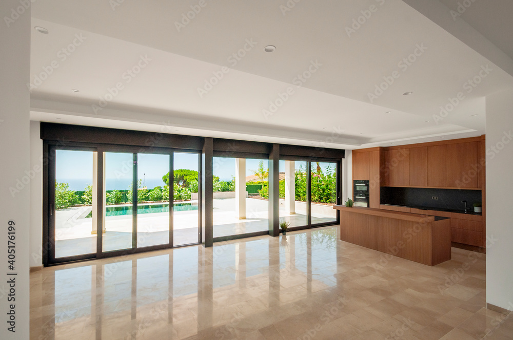 Large unfurnished living room with combined kitchen with modern furniture.