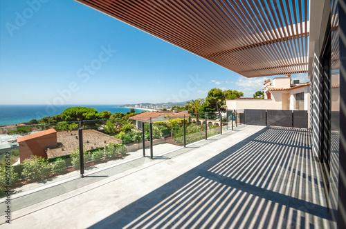 Sea view from a large terrace with a glass partition.