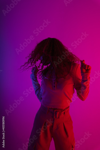 Fashion portrait young asian girl dancing on neon light studio background.