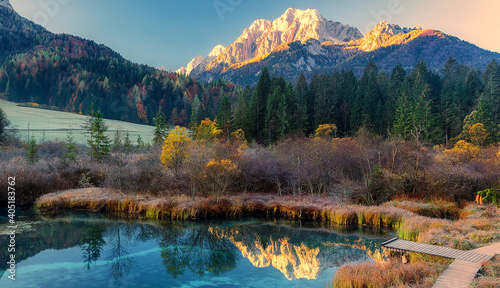 Wonderful picturesque Scene. Amazing Misty Morning. Beautiful nature Scenery. scenic view of Majestic Mountain Peak with river foreground, shoot in morning in Autumn season, Fantastic Alpine Landscape