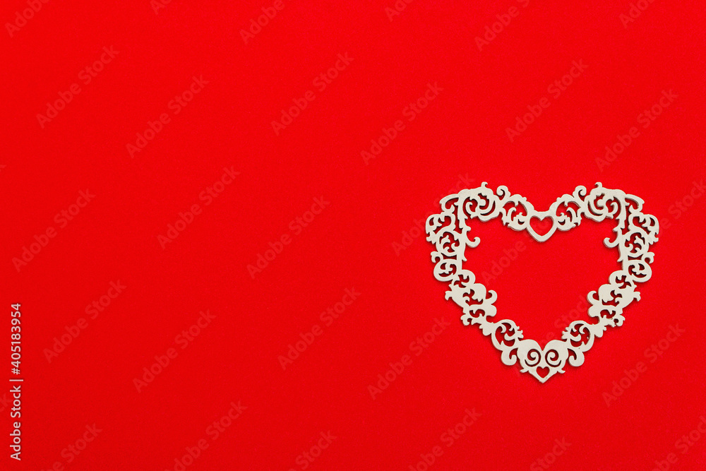 Festive composition with openwork white heart on red background