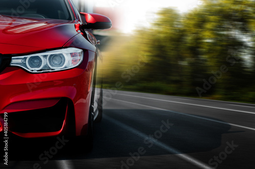 Billede på lærred Red sport car on the asphalt road