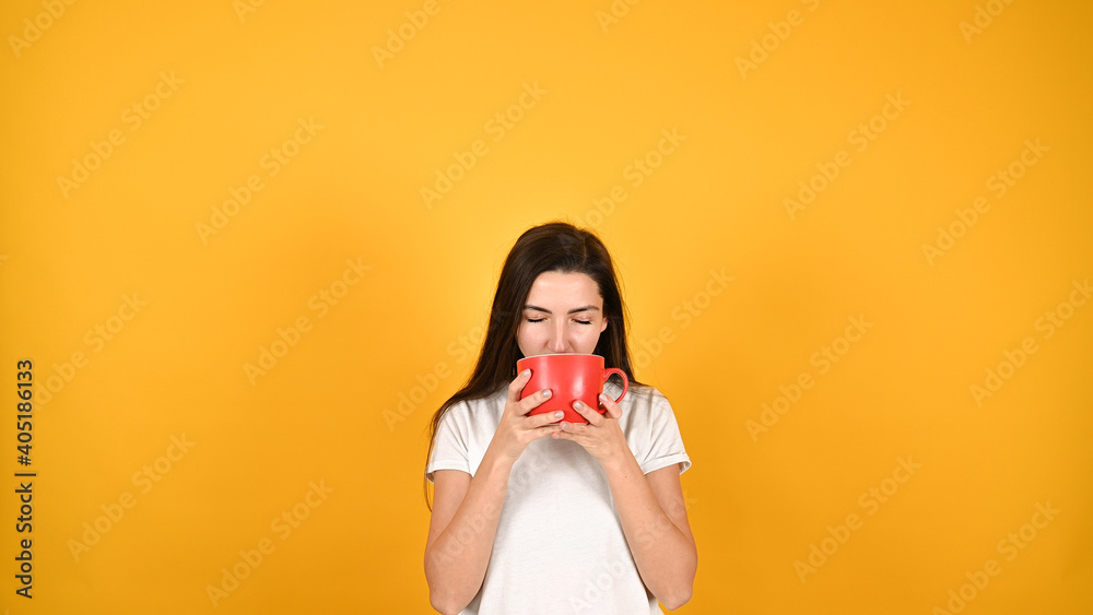 woman with red cup, on yellow background woman with red cup, on yellow background
