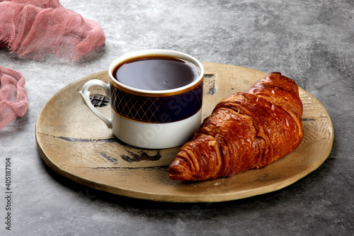 fresh croissants with a cup of coffee on the table. Traditional French breakfast