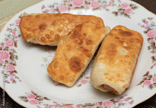 Sausage in dough fried on a breakfast plate.