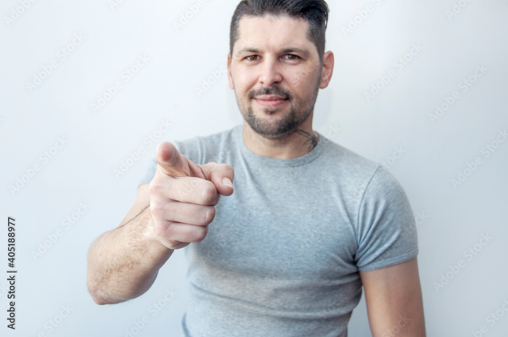 Hipster beard man pointing at you, wearing casual gray t-shirt with pointing finger. You are the one I need! Index finger. Promo people. We are waiting for you. Hipster beard man pointing at you, wearing casual gray t-shirt with pointing finger. You are the one I need! Index finger. Promo people. We are waiting for you.