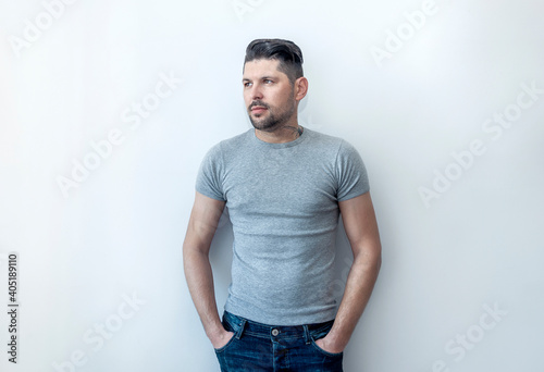 Young handsome man with happy face smiling with crossed arms looking at the camera. Positive person. © steftach