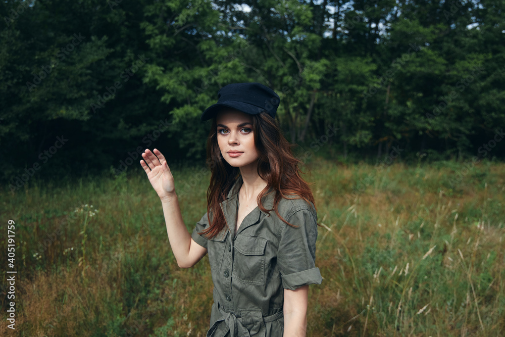 woman in the forest Woman in green jumpsuit black cap look ahead freedom fresh air 
