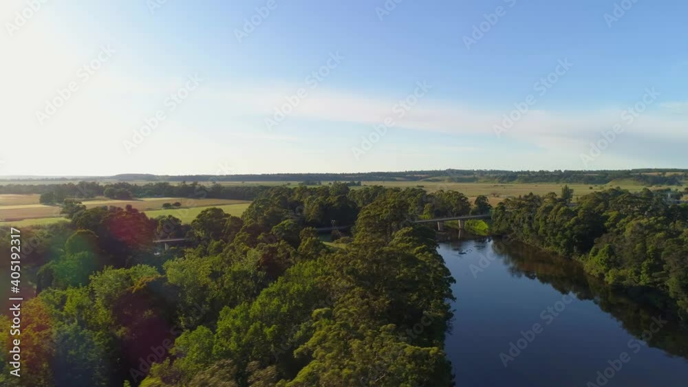 Flight across Snowy River towards highway bridge at sunset. Orbost, Victoria, Australia Flight across Snowy River towards highway bridge at sunset. Orbost, Victoria, Australia