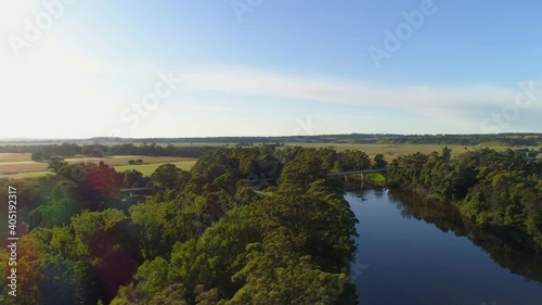 Flight across Snowy River towards highway bridge at sunset. Orbost, Victoria, Australia photo