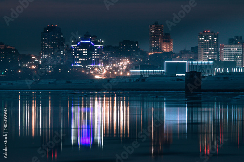 night city view with bright illumination and their beautiful reflection in river water