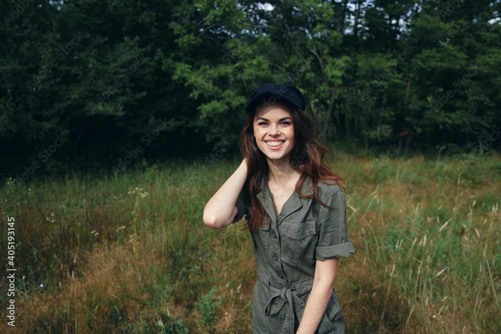 woman in the forest Cheerful smile black cap fresh air freedom green leaves woman in the forest Cheerful smile black cap fresh air freedom green leaves