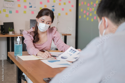 business worker meeting and brainstorm for startup new business. man and woman wear protective face mask in new normal office preventing coronavirus COVID-19 spreading. New normal business concept.