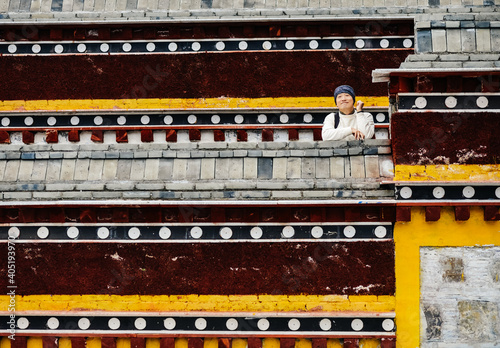 Asian male traveling in Labrang Monastery, Xiahe, Gansu, China photo