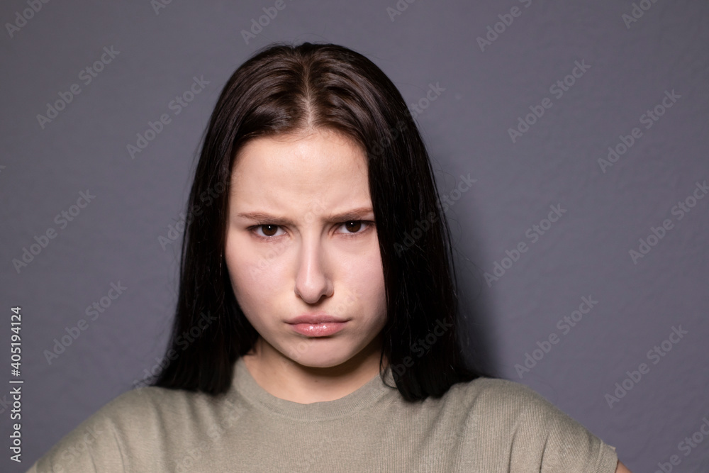 portrait of charming shocked brunette woman in marsh color t-shirt on grey wall background. actress acting, emotion portrait of charming shocked brunette woman in marsh color t-shirt on grey wall background. actress acting, emotion
