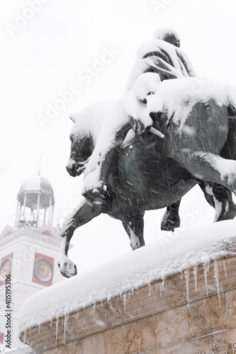 Photography Horse statue covered in snow during the historic snowfall in Puerta del Sol, Mad