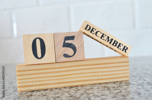 December 5, Cover design with number cube on a white background and granite table.