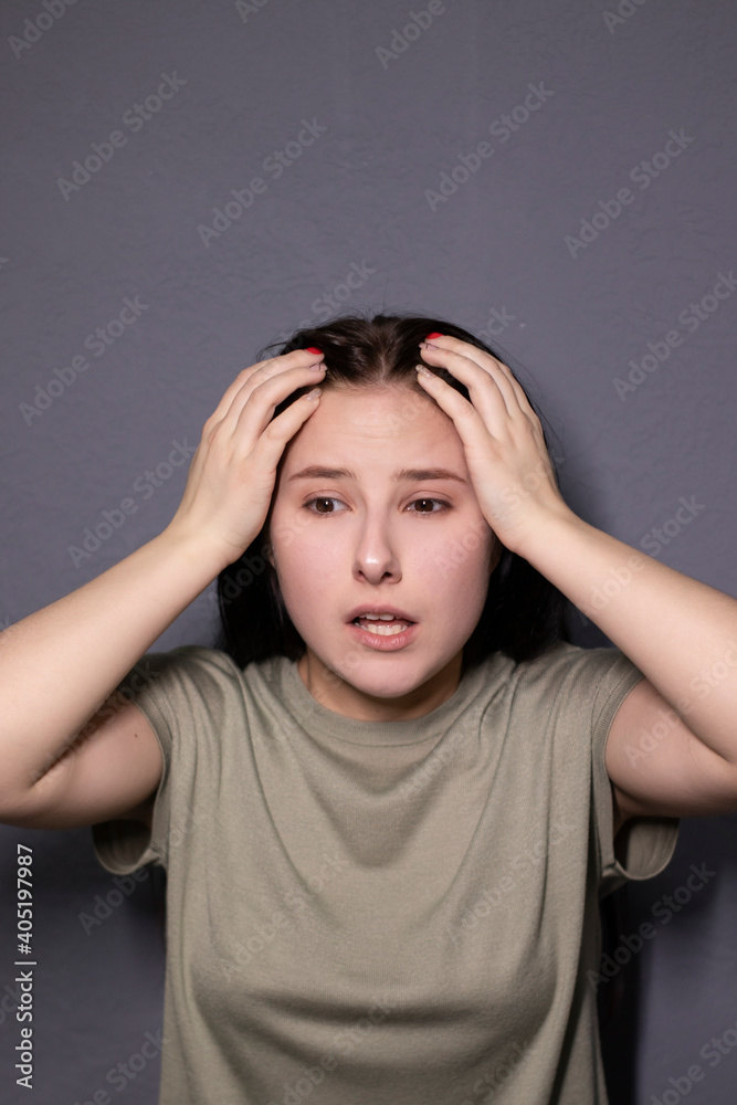 portrait of charming scared brunette woman in marsh color t-shirt on grey wall background. actress acting, emotion portrait of charming scared brunette woman in marsh color t-shirt on grey wall background. actress acting, emotion