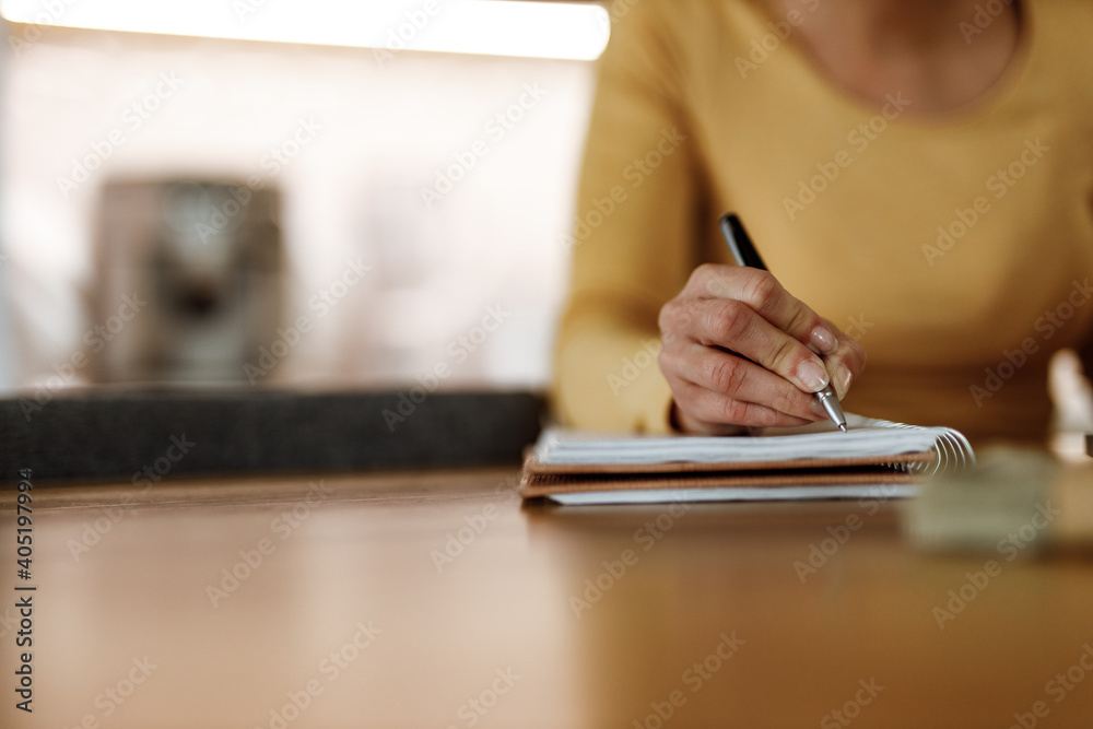 Fototapeta premium Holding pen, writing something, home office.