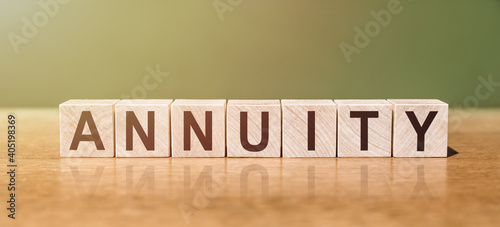 ANNUITY word written on wooden blocks on wooden table. Concept for your design.