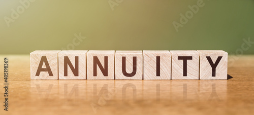 ANNUITY word written on wooden blocks on wooden table. Concept for your design. photo