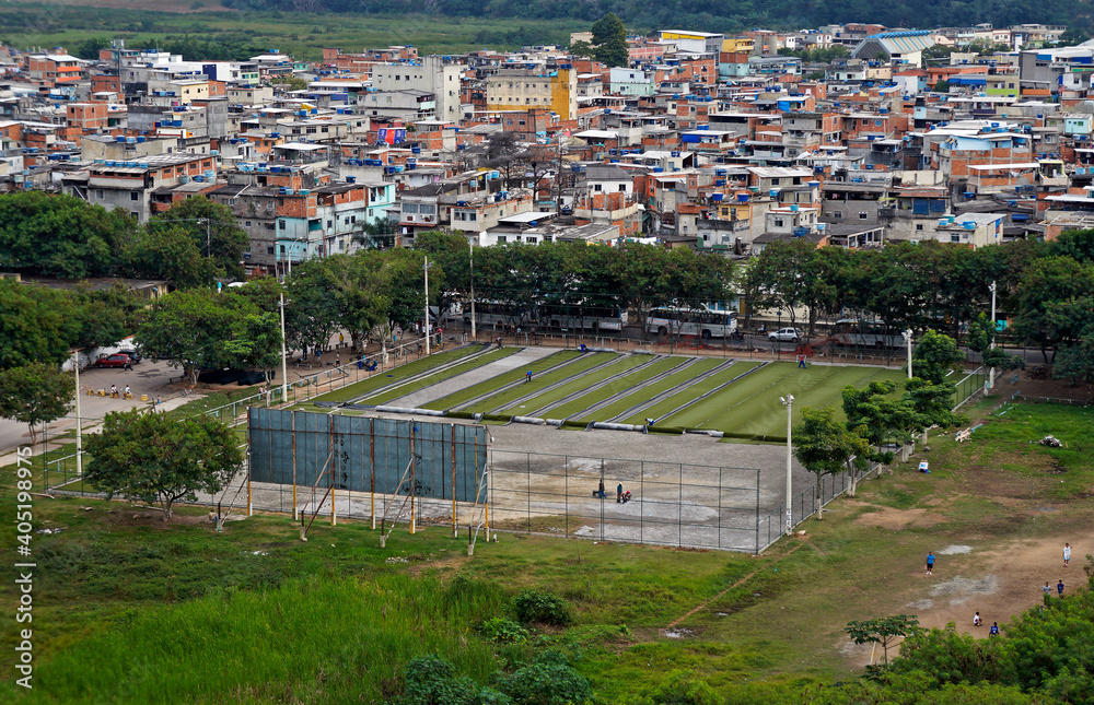 Application of synthetic grass on a soccer field in the favela (Rio das Pedras), Rio de Janeiro, Brazil