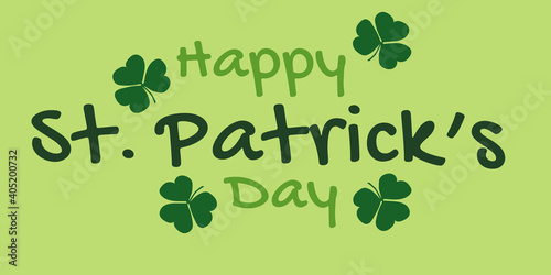 Banner with the text: Happy St. Patrick's Day on a green background with a shamrock. The words are green. Can be used as a greeting card or poster.