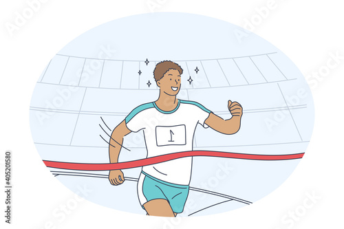 Athletics, running, marathon competition concept. Young smiling man sportsman athlete taking part in running sport marathon and crossing finish line with best result. Active healthy lifestyle