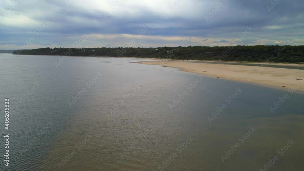 Turning flight over ocean coastline and Snowy River estuary in Marlo, Australia Turning flight over ocean coastline and Snowy River estuary in Marlo, Australia