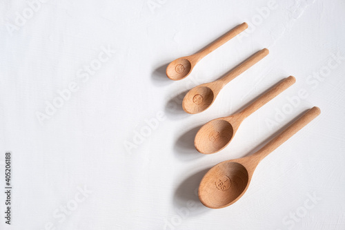 Wooden measuring spoons on a white background with copyspace