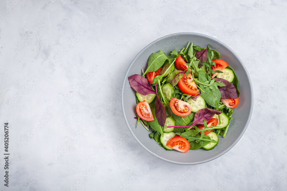 Healthy fresh salad of vegetable cucumber, tomato, spinach, arugula Healthy fresh salad of vegetable cucumber, tomato, spinach, arugula