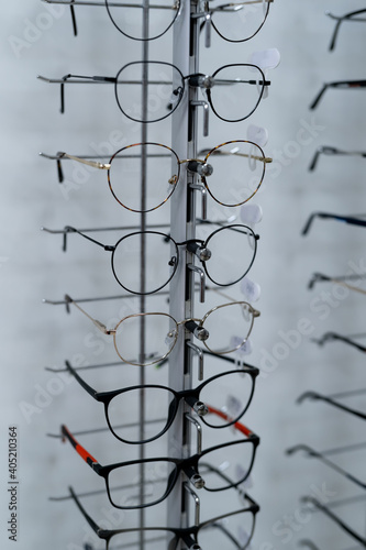 Raw of fashion elegance glasses in the store. Showcase with spectacles in modern ophthalmic store.