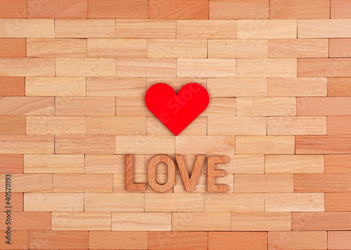 The inscription love in wooden letters and a red heart.