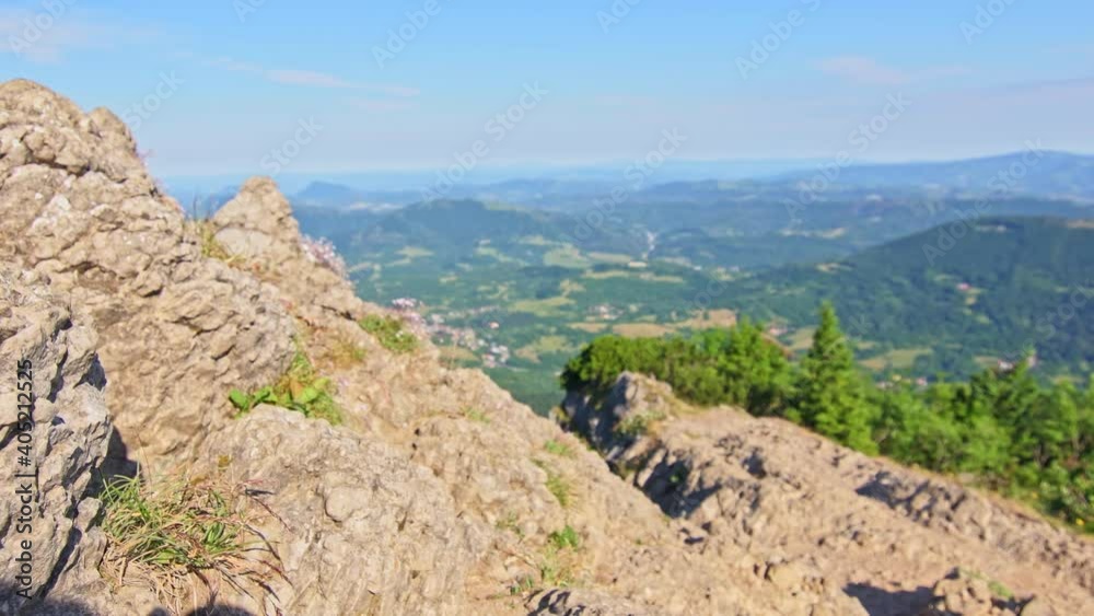 Slow translation from blurred and out of focus view of mountains and forests to focused sharp look. Summer day in mountains. Rock in foreground, hills in background. Slow translation from blurred and out of focus view of mountains and forests to focused sharp look. Summer day in mountains. Rock in foreground, hills in background.