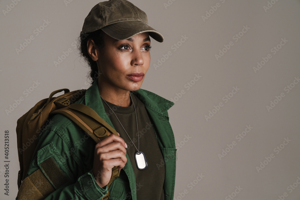 Confident african american soldier woman posing with backpack