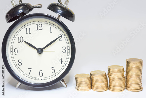 Saving money as a concept. Vintage retro stack of gold coins on the wooden background to represent It's time to do investing for retirement planning.